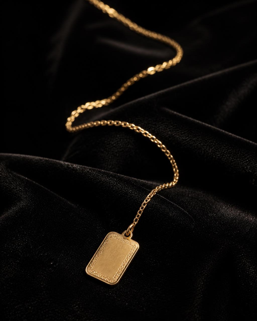 Engraved pendant chain photographed in warm light